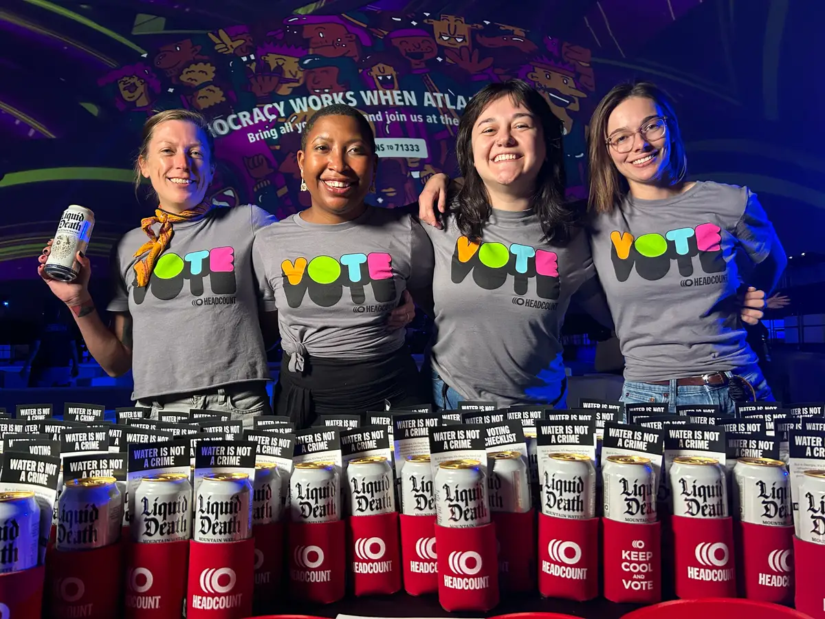 Four volunteers with liquid death cans at an event in Georgia
